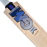 Close-up of a wooden cricket bat showing the blade, with visible GM branding in blue, black, and silver on a light natural wood background.